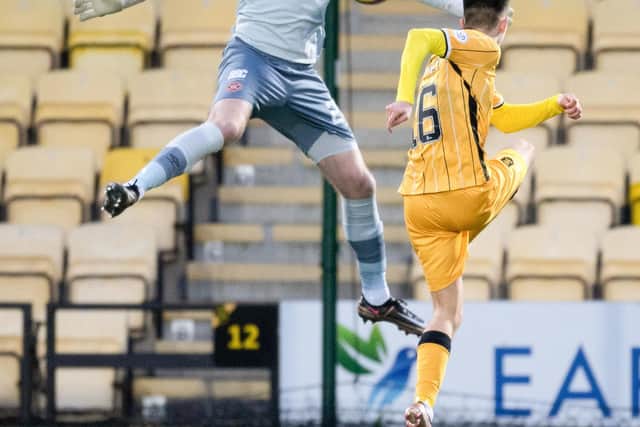 Hearts goalkeeper Zander Clark is lobbed by Livingston winger Steven Bradley only for Kye Rowles to clear off the line. Picture: Ross Parker / SNS