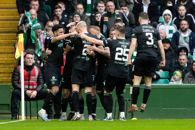 The Hibs players celebrate after Josh Campbell opened the scoring for the visitors at Celtic Park. Picture: SNS