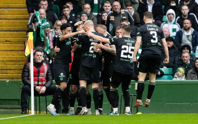 The Hibs players celebrate after Josh Campbell opened the scoring for the visitors at Celtic Park. Picture: SNS