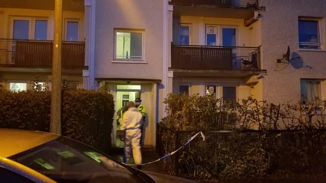 The entrance to a block of flats in Muirhouse Place West has been taped off.