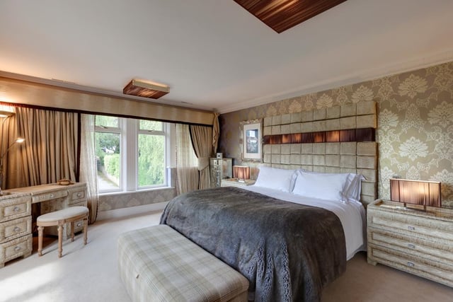 The property boasts four bedrooms in total, including this spacious master with double doors leading out onto a Juliet balcony, and a stylish en-suite bathroom with a rain head shower and spa jets.