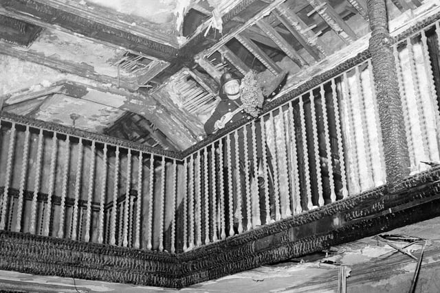 A fireman shovels debris from the inside balcony of Carrington House after the fire at Fettes College in February 1963.