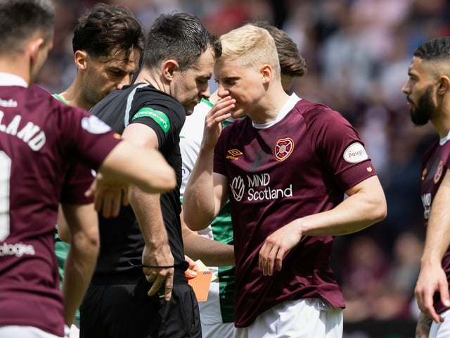 Alex Cochrane pleads with referee Don Robertson after being sent off