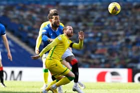 Martin Boyle of Hibs competes for the ball with Rangers' Connor Goldson