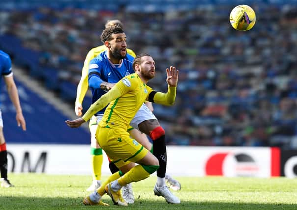 Martin Boyle of Hibs competes for the ball with Rangers' Connor Goldson
