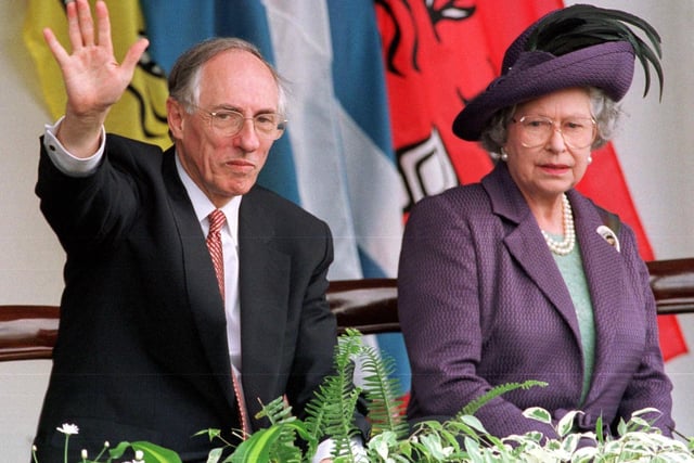 Queen Elizabeth II with Donald Dewar, who was Scottish First Minister at the time, watching the parades after the opening of the Scottish Parliament in Edinburgh 01 July 1999.