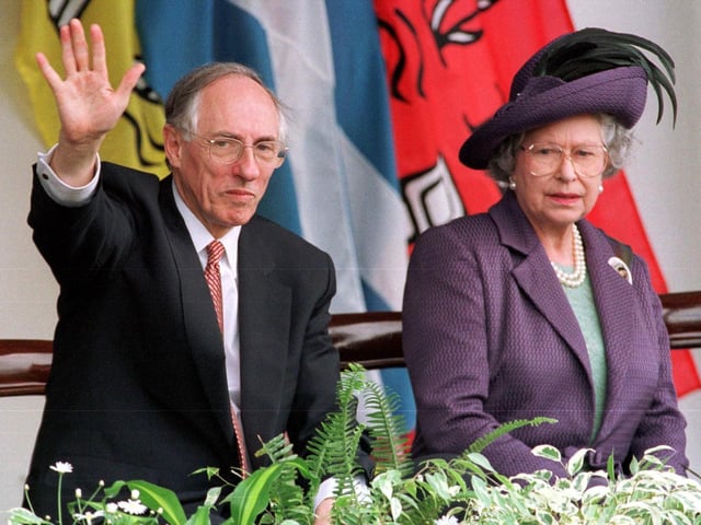 Queen Elizabeth II with Donald Dewar, who was Scottish First Minister at the time, watching the parades after the opening of the Scottish Parliament in Edinburgh 01 July 1999.