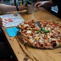 Pizza Geeks will be giving away a free slice to those in need.