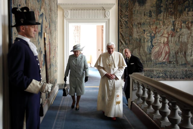 Queen Elizabeth II and Prince Philip, Duke of Edinburgh, walking with Pope Benedict XVI in the Palace of Holyroodhouse, the Queen's official residence in Scotland, on September 16, 2010.