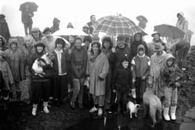 Walkers and their dogs brave the rain to wash their faces  in the morning dew at the top of Arthur's Seat during the traditional May Day ceremony in 1987.