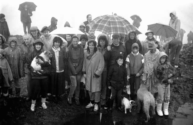 Walkers and their dogs brave the rain to wash their faces  in the morning dew at the top of Arthur's Seat during the traditional May Day ceremony in 1987.