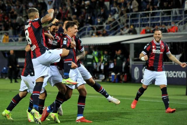 Aaron Hickey is mobbed by team-mates after giving Bologna the lead in their Serie A clash with Genoa. Picture: SNS