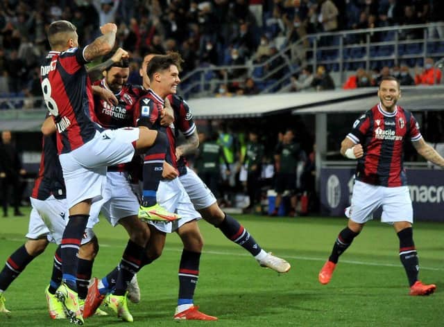 Aaron Hickey is mobbed by team-mates after giving Bologna the lead in their Serie A clash with Genoa. Picture: SNS