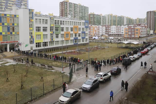 Voters queue at a polling station in St. Petersburg, Russia, at noon local time on Sunday, March 17, 2024. The Russian opposition has called on people to head to polling stations at noon on Sunday in protest as voting takes place on the last day of a presidential election that is all but certain to extend President Vladimir Putin's rule after he clamped down on dissent. AP can't confirm that all the voters seen at the polling station at noon were taking part in the opposition protest.