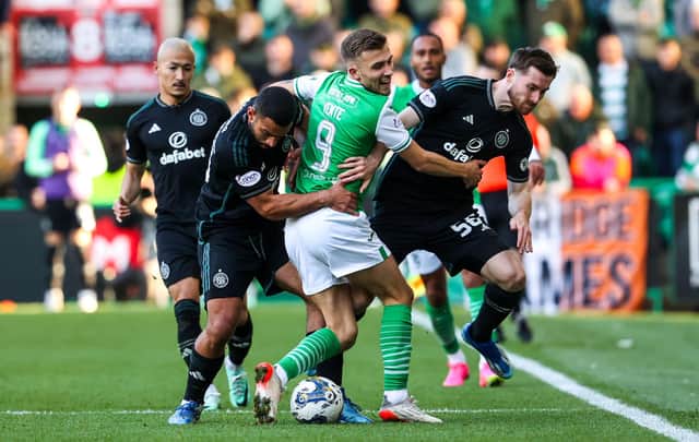 Outnumbered but not outfought - Dylan Vente wrestles with two Celtic defenders.