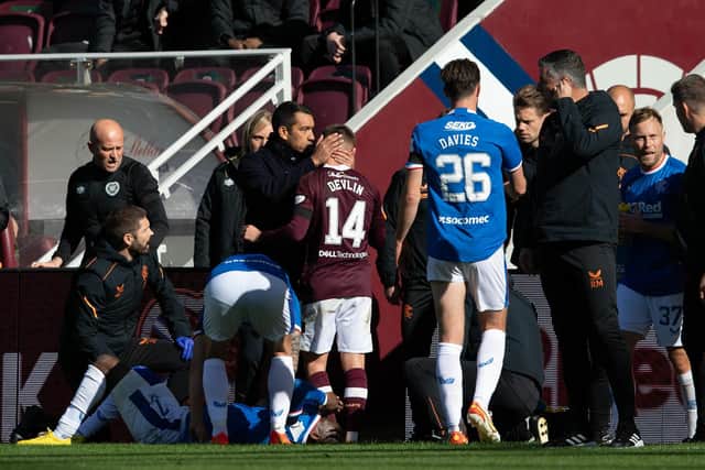 Hearts' Cammy Devlin is spoken to my Rangers manager Giovanni Van Bronckhorst as he walks off the field following his red card. Picture: SNS