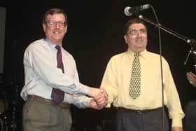 Ulster Unionist leader David Trimble, left, and SDLP leader John Hume shake hands on stage during a concert to promote the yes vote in the referendum on the Good Friday Agreement (Picture: Gerry Penny/AFP via Getty Images)