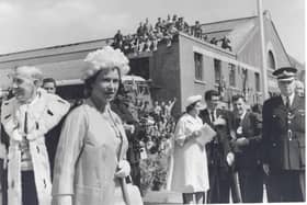 Staff sit of the roof of Dalkeith Bus Station to catch a glimpse of The Queen during her visit to the county in June, 1961. Photo courtesy Midlothian Council Local Studies.