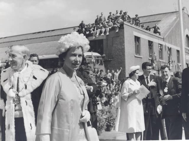 Staff sit of the roof of Dalkeith Bus Station to catch a glimpse of The Queen during her visit to the county in June, 1961. Photo courtesy Midlothian Council Local Studies.
