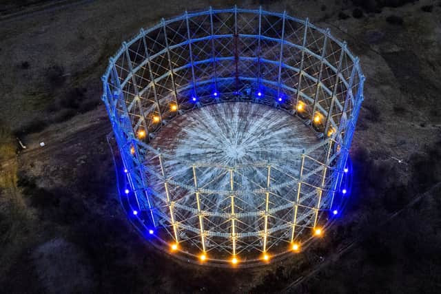 The last surviving gasholder from the Granton Gasworks in North Edinburgh, is illuminated in the colours of the Ukrainian flag as a gesture of solidarity with the people of Ukraine following the Russian invasion. Photo: Jane Barlow/PA Wire