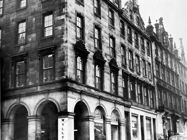 Exterior of Willys, furniture store, on the corner of Victoria Street and Melbourne Place (street no longer exists) in December 1965. Melbourne Place was the name of part of George IV Bridge.