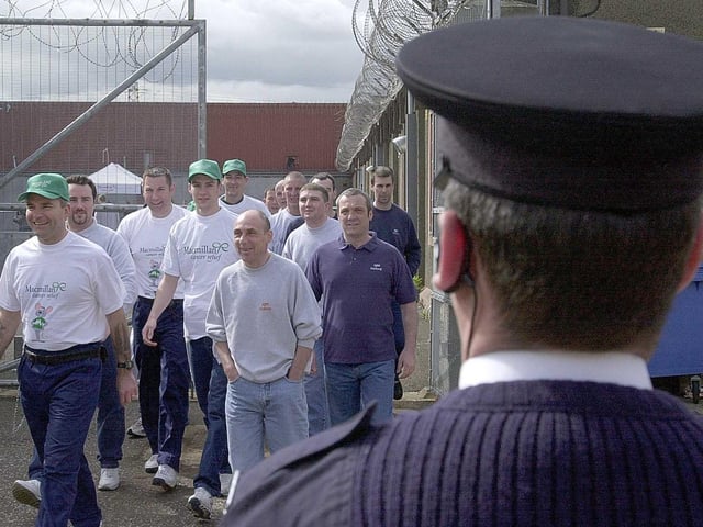 Prisoners of Saughton Prison on a sponsored walk, Edinburgh; May 18, 2001. The prisoners volunteered to walk four miles around the prison walls for the Macmillan cancer charity.