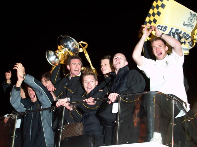 Livingston players celebrate their CIS Cup win on an open top bus in March 2004. They had beaten Hibs 2-0 to win their only major trophy to date