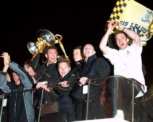Livingston players celebrate their CIS Cup win on an open top bus in March 2004. They had beaten Hibs 2-0 to win their only major trophy to date