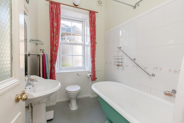 The property's main bathroom has a three-piece suite with shower above the bath.