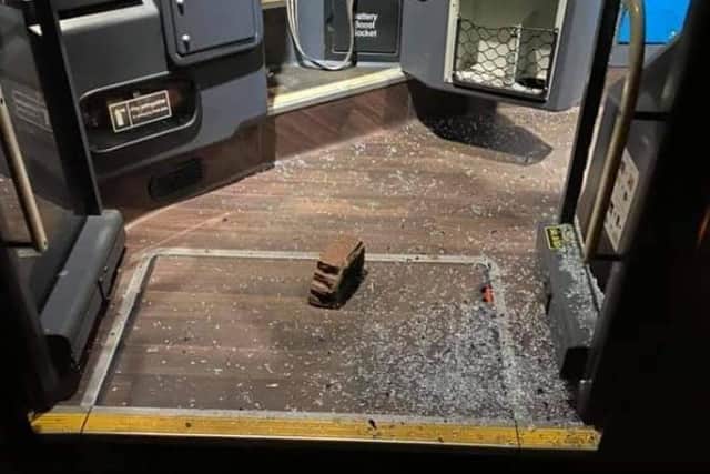 A brick and glass on the floor of one vehicle.