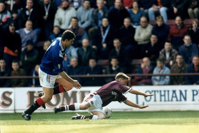 John Robertson being brought to the ground by Gordan Petric. Picture: Julie Bull/TSPL