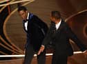 Actor Will Smith (R) slaps US actor Chris Rock onstage during the 94th Oscars at the Dolby Theatre in Hollywood, California