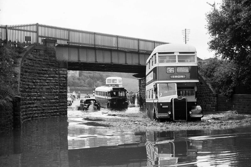 A bus ploughs through the water under Slateford Railway Bridge after the torrential rain following the freak thunderstorm in July 1953.