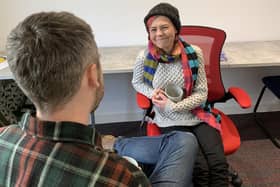 One of the staff members at North Edinburgh Community Resource Centre having a conversation with a client at its warm bank.