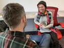 One of the staff members at North Edinburgh Community Resource Centre having a conversation with a client at its warm bank.