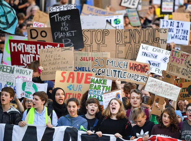 Protesters march and hold placards as they take part in the Global Climate Strike in Edinburgh in 2019 (Picture: Jeff J Mitchell/Getty Images)