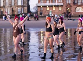 Several women smiled as they prepared for their swim, despite the freezing cold temperatures.