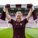 Esther Morgan poses with a maroon-and-white scarf at Tynecastle Park after agreeing a two-year deal to join Hearts. Picture: HMFC
