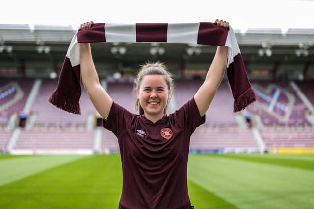 Esther Morgan poses with a maroon-and-white scarf at Tynecastle Park after agreeing a two-year deal to join Hearts. Picture: HMFC
