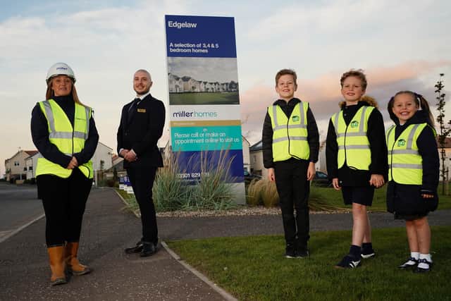 Pictured in their new high-vis vests are pupils Findlay (8), Arron (8) and Arya (5), along with Laura Martin, assistant site manager at Miller Homes' Edgelaw development, and Eddie Zanre, development sales manager. Picture by Stewart Attwood.