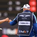 Grant Forrest fist bumps his caddie David Kenny during the second round of the Genesis Scottish Open at The Renaissance Club. Picture: Andrew Redington/Getty Images.