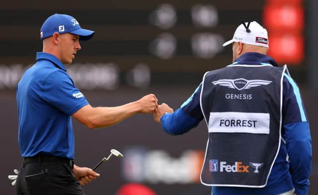 Grant Forrest fist bumps his caddie David Kenny during the second round of the Genesis Scottish Open at The Renaissance Club. Picture: Andrew Redington/Getty Images.