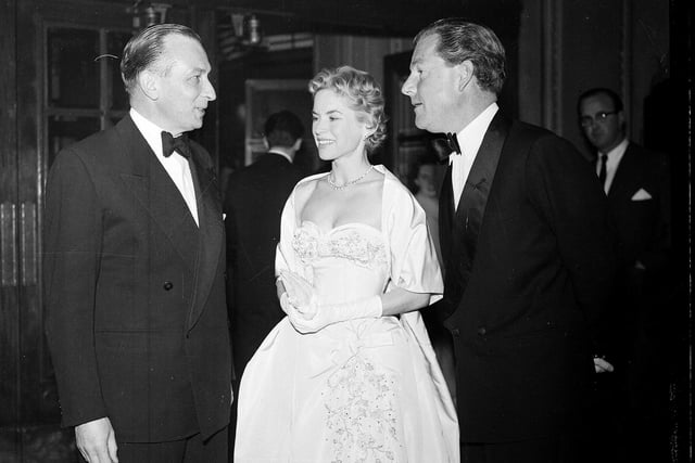 Mr Forsyth Hardy, Honorary Secretary of the Edinburgh Film Festival, talks to actors Kenneth More and Muriel Pavlov at the Playhouse Cinema at a special presentation of 'Reach for the Sky' in 1956.