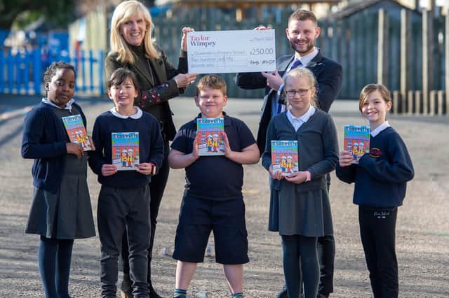 Local Taylor Wimpey Sales Executive Calum MacLean with Mrs Aileen McLean Depute Teacher and members of the P5 Eco Group at Queensferry Primary School celebrating their donation of £250 and Ecotastic Activity books.