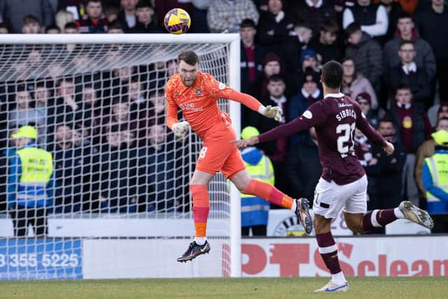 Zander Clark heads clear during the first half of Hearts' 1-1 draw with St Mirren in Paisley. Picture: SNS