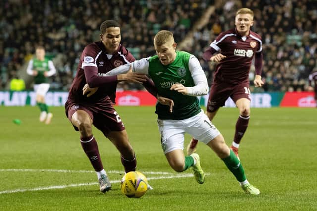 Hearts defender Toby Sibbick battles with Hibs forward Chris Mueller in a frenetic derby at Easter Road