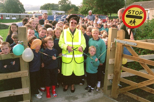 Pictured at Wharncliffe Side Primary School in 1999, where lollipop lady Christine Colbridge cut the tape to officially open the new entrace and pathway into the school. The path was built by  the training team project members from the Stocksbridge Steel Valley and Upper Don Valley Project.