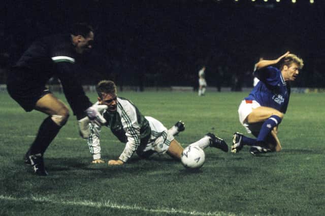 John Burridge stoops to gather the ball as Hibs defeat Rangers in the 1991 Skol Cup semi-final. Picture: SNS