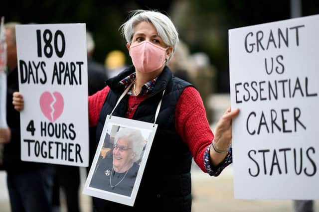 A member of the Care Home Relatives Scotland group  taking part in a demonstration outside Holyrood in September to campaign for more visitor access to relatives in care homes. (Photo by Jeff J Mitchell/Getty Images)