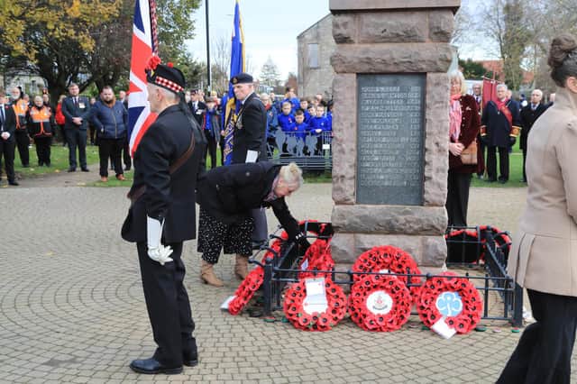 Loanhead Community Development Association Chairwoman Irene Hogg laying a wreath at the town's Remembrance Sunday event. Photo by Joe Gilhooley.